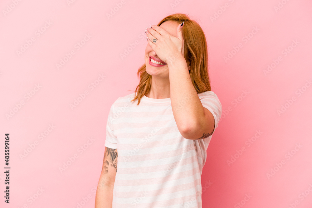 Young caucasian woman isolated on pink background covers eyes with hands, smiles broadly waiting for a surprise.
