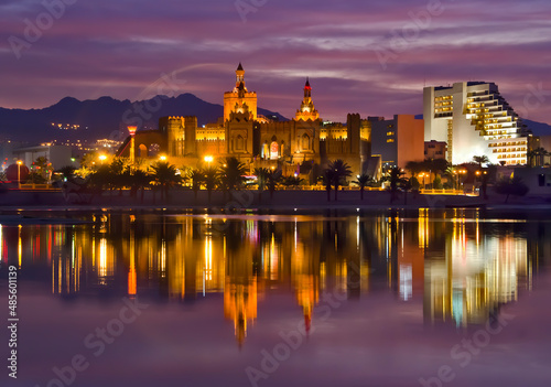 Eilat tourist resort city by the night or after sunset, colorful reflections in the water