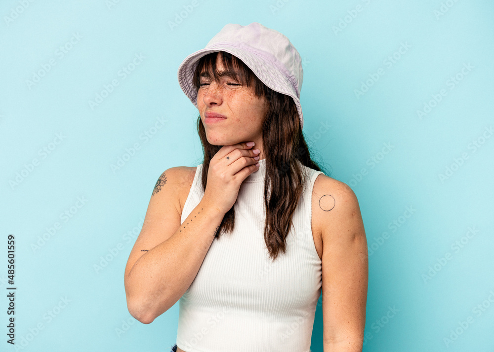 Young Argentinian woman isolated on blue background suffers pain in throat due a virus or infection. Young Argentinian woman isolated on blue background suffers pain in throat due a virus or infection.