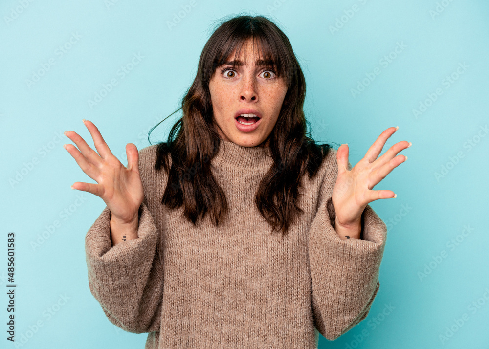 Young Argentinian woman isolated on blue background screaming to the sky, looking up, frustrated. Young Argentinian woman isolated on blue background screaming to the sky, looking up, frustrated.