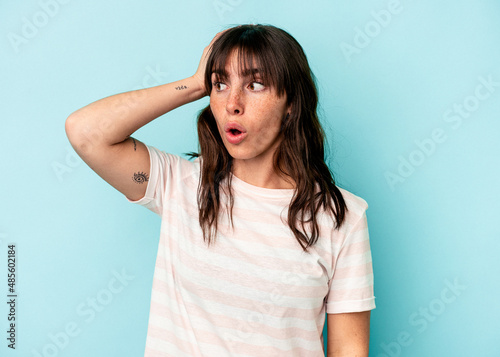 Young Argentinian woman isolated on blue background being shocked, she has remembered important meeting.