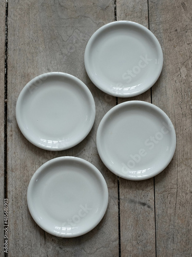 Vintage empty porcelain plates on a wooden table