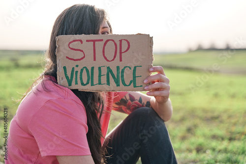 Fotografija Woman covering her face with a STOP VIOLENCE carter
