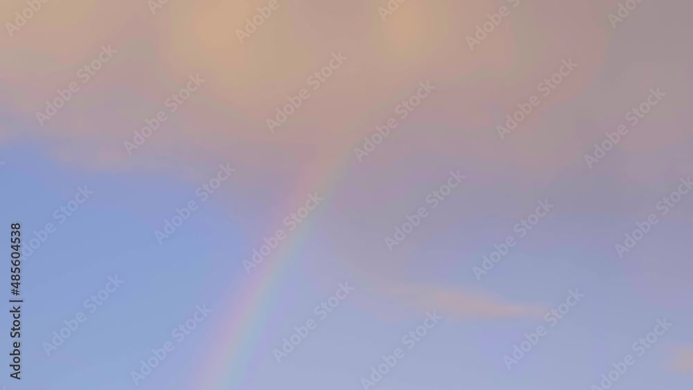 Multicolored rainbow and clouds in the sky after the rain Multicolored rainbow and clouds in the sky after the rain