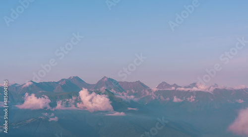 Fototapeta Naklejka Na Ścianę i Meble -  beautiful view of the mountains of the Caucasus range in pink clouds at sunset, natural background landscape