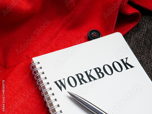 A Workbook with pen on the sofa.