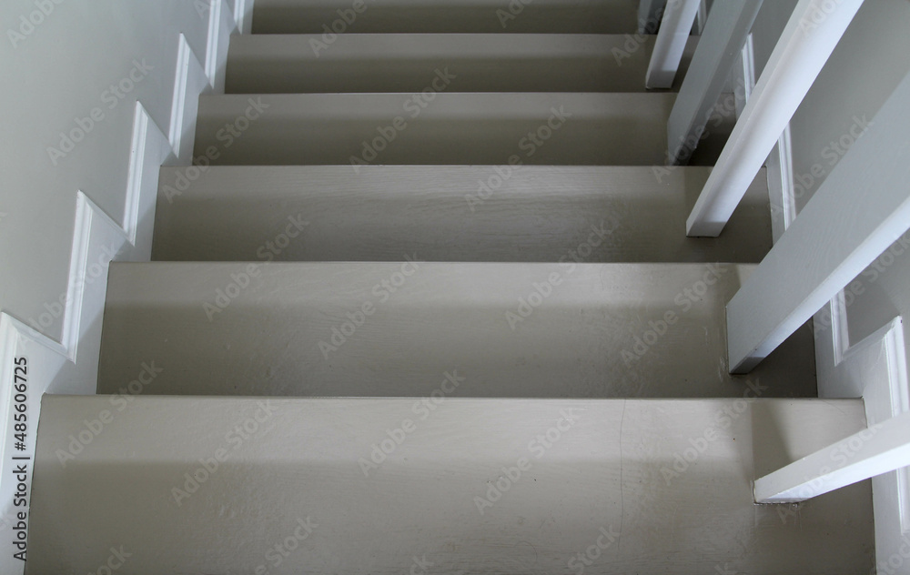 White walls, white railings and grey stairs of a modern house. White walls, white railings and grey stairs of a modern house.