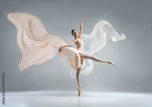 Fotografija Beautiful ballerina dancing in the body color ballet leotard with body color cloth