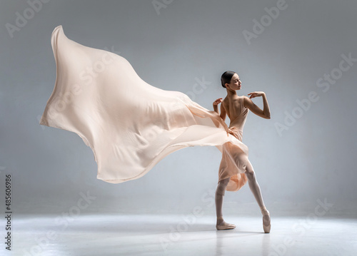 Beautiful ballerina dancing in the body color ballet leotard with body color cloth. She danced on ballet pointe shoes.