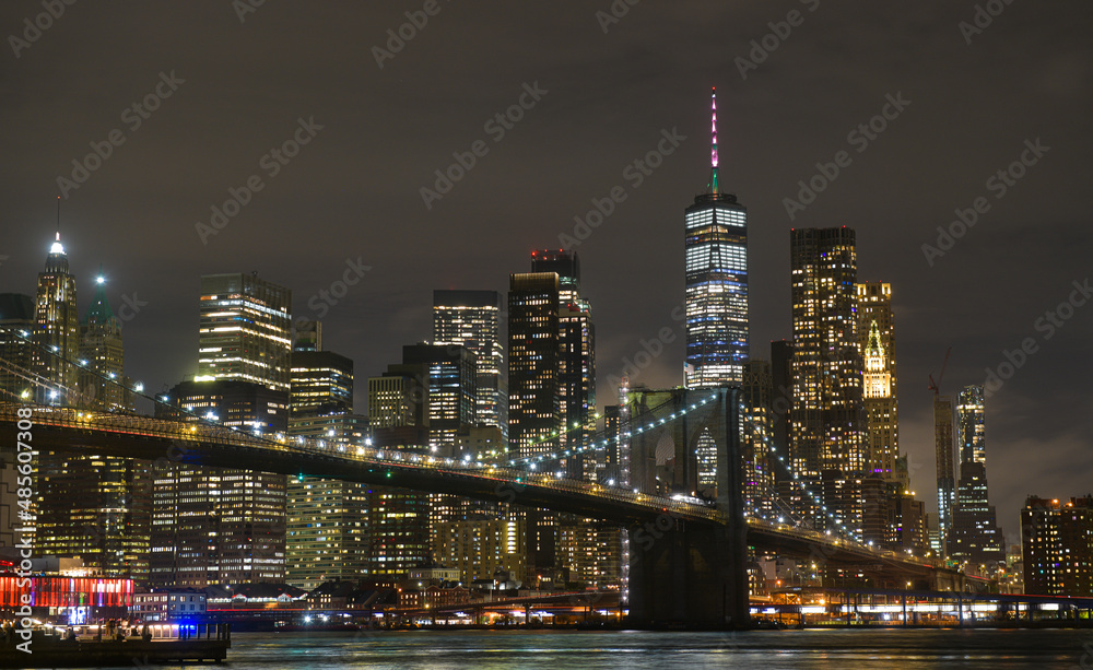Brooklyn Bridge under the full moon night landscape. This amazing constructions is one of the most known landmarks in New York. - obrazy, fototapety, plakaty 