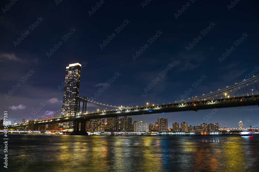Manhattan Bridge under the full moon night landscape. This amazing constructions is one of the most known landmarks in New York. - obrazy, fototapety, plakaty 