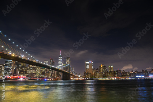 Brooklyn Bridge under the full moon night landscape. This amazing constructions is one of the most known landmarks in New York. © Dragoș Asaftei