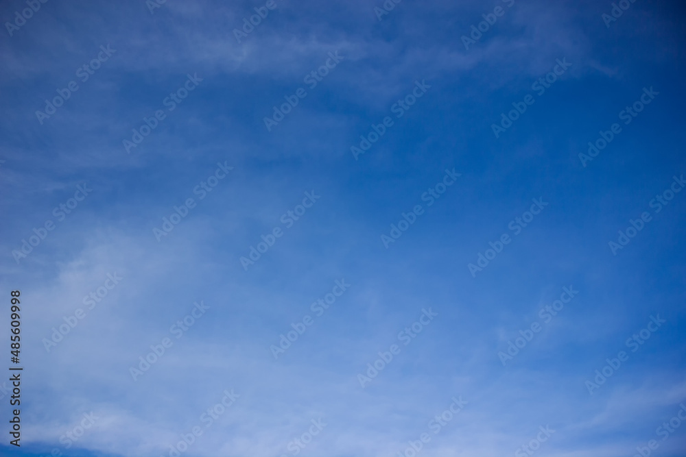 Blurred sky background. White mist across the blue sky.