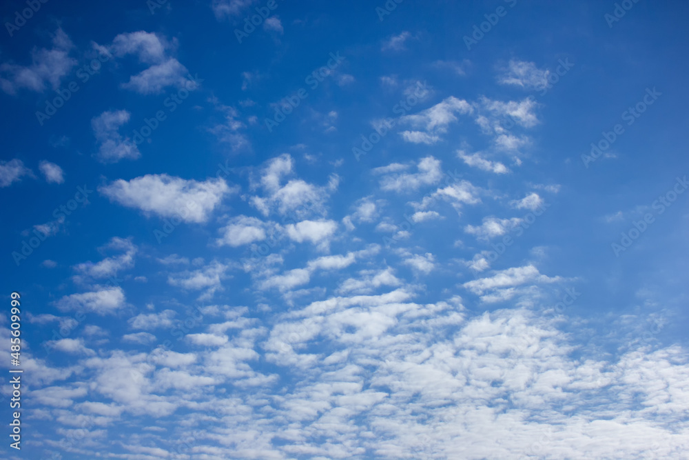 Shallow white blurred clouds on a background of blue sky