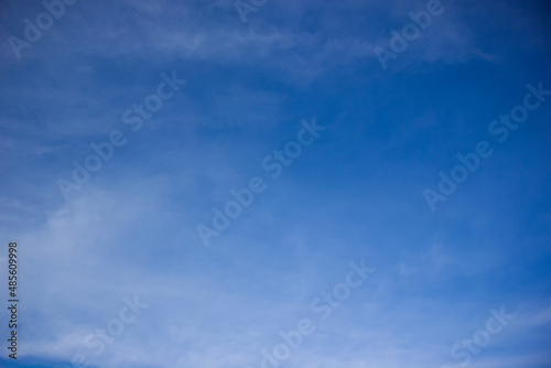 Blurred sky background. White mist across the blue sky.