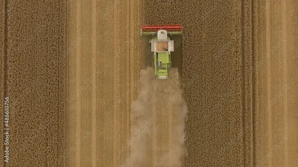 Harvest drone following above combine harvester as it crops a field Harvest drone following above combine harvester as it crops a field