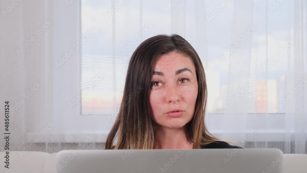 brunette girl blogger talking with friends on social networks on laptop using wireless internet. Positive young woman shopping online on the website brunette girl blogger talking with friends on social networks on laptop using wireless internet. Positive young woman shopping online on the website
