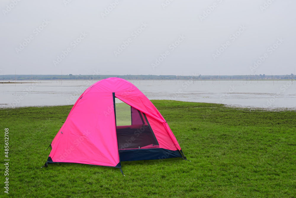 Pink tent in the middle of fields and lakes