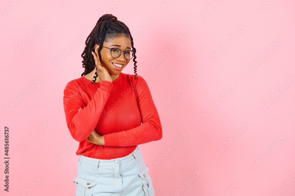 Beauty portrait of a young black healthy woman holding glasses and looking at camera Beauty portrait of a young black healthy woman holding glasses and looking at camera