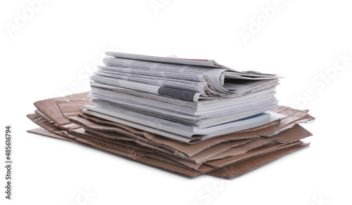 Stack of cardboard and newspapers on white background. Recycling rubbish