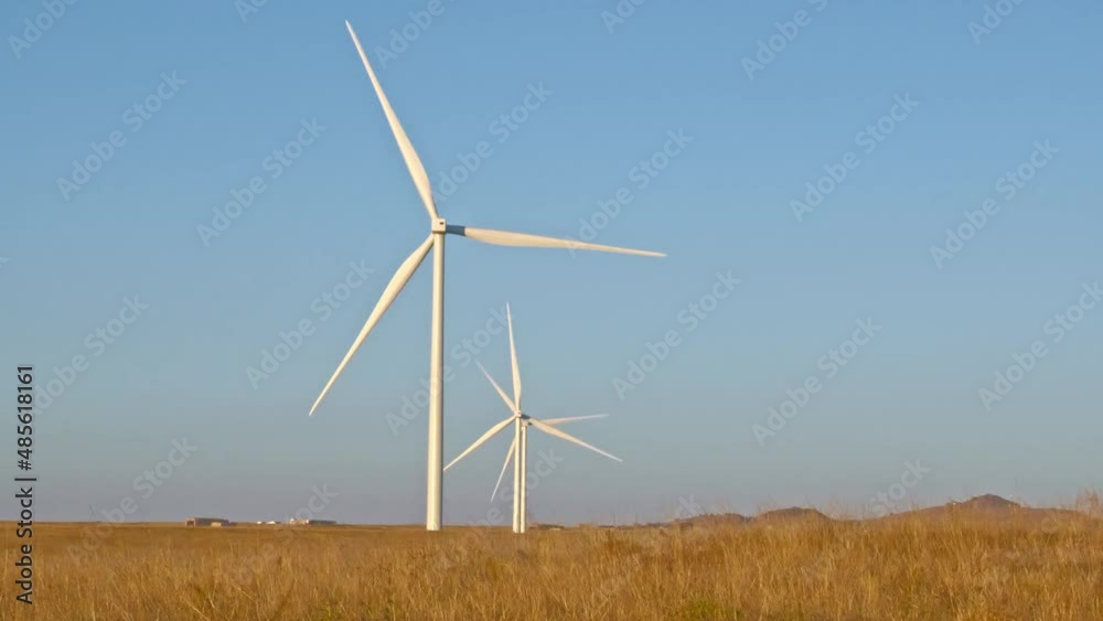 Windmills In A Row On A Golden Wyoming Plain Against A Blue Sky 39Sec Windmills In A Row On A Golden Wyoming Plain Against A Blue Sky 39Sec