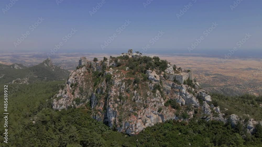 Aerial 4K landscape view of medieval Kantara Castle which is located at the Mountains in North Cyprus. Medieval Castle is surrounded with rocks & trees with an amazing view of Mediterranean Sea. Aerial 4K landscape view of medieval Kantara Castle which is located at the Mountains in North Cyprus. Medieval Castle is surrounded with rocks & trees with an amazing view of Mediterranean Sea.