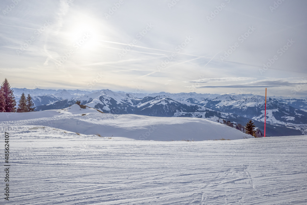 Kirchberg, Austria - December 26, 2021: Ski resort Kitzski in the Alps. Mountain snow peaks, skiers in equipment