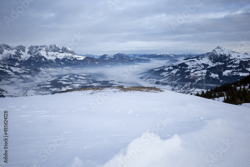 Kirchberg, Austria - December 26, 2021: Ski resort Kitzski in the Alps. Mountain snow peaks, skiers in equipment
