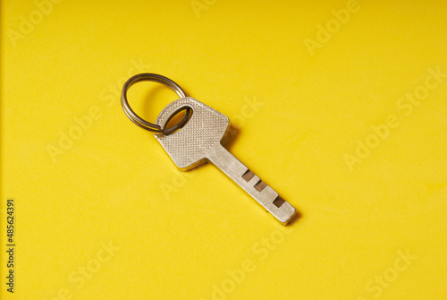 The key to the lock on a yellow background.