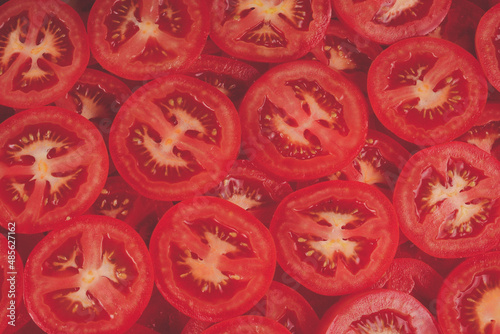 Sliced tomato background. Top view. © Nikolay