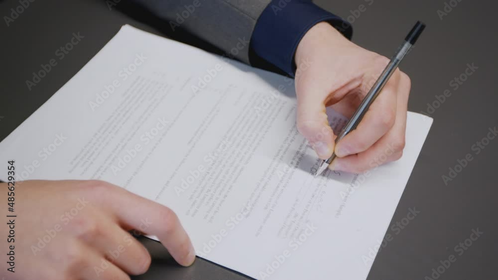 Business documents. Unrecognizable businessman filling contract before signing at office, top view, tracking shot Business documents. Unrecognizable businessman filling contract before signing at office, top view, tracking shot