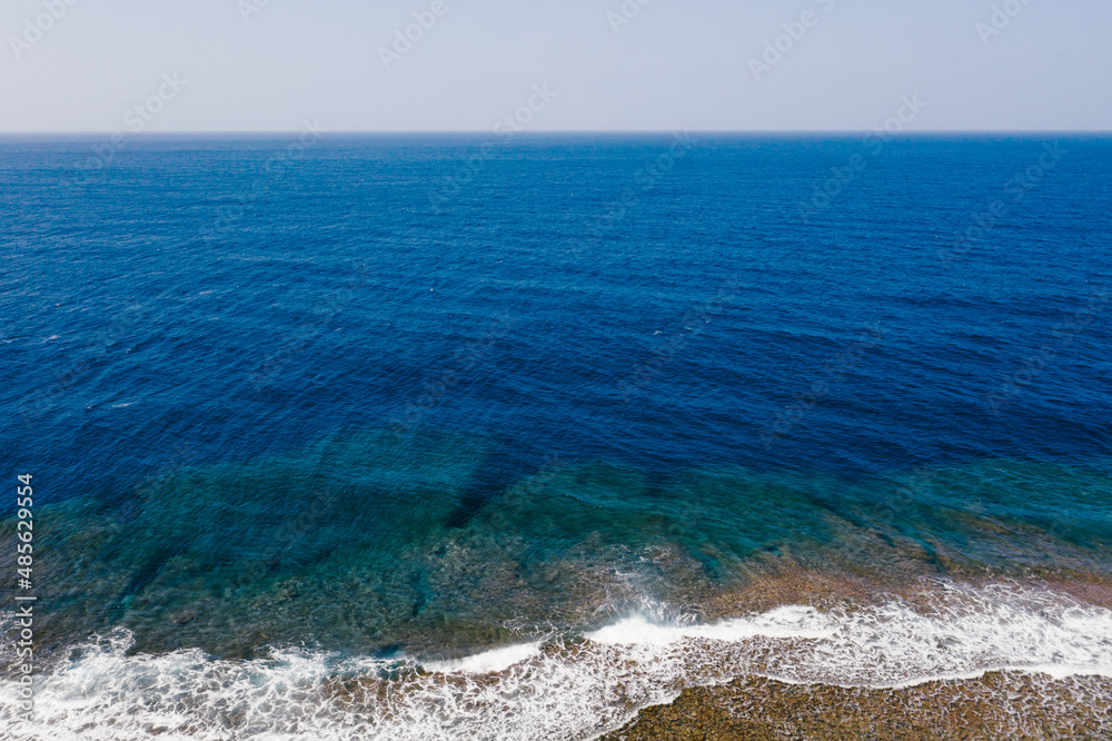 Deep blue ocean landscape with waves and coral reefs