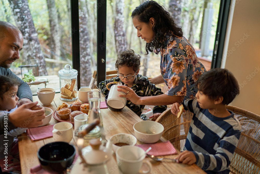 Family eating at dining table in cabin Family eating at dining table in cabin
