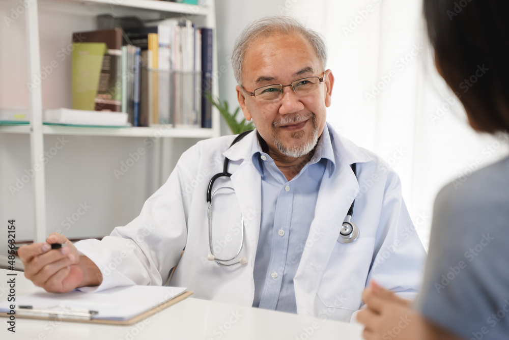 Close up doctor talking with the patient at a desk in the clinic Close up doctor talking with the patient at a desk in the clinic