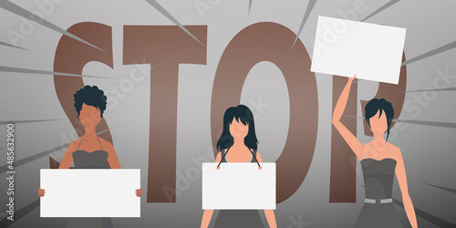 Girls with a banner in their hands against the background of the word STOP. The concept of expressing thoughts, dissatisfaction and protests.