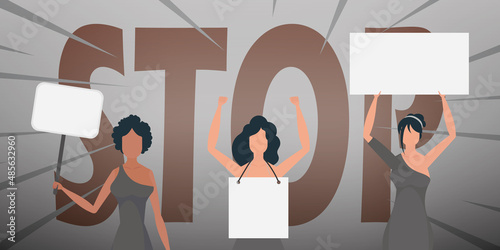 Girls with a banner in their hands against the background of the word STOP. The concept of expressing thoughts, dissatisfaction and protests.
