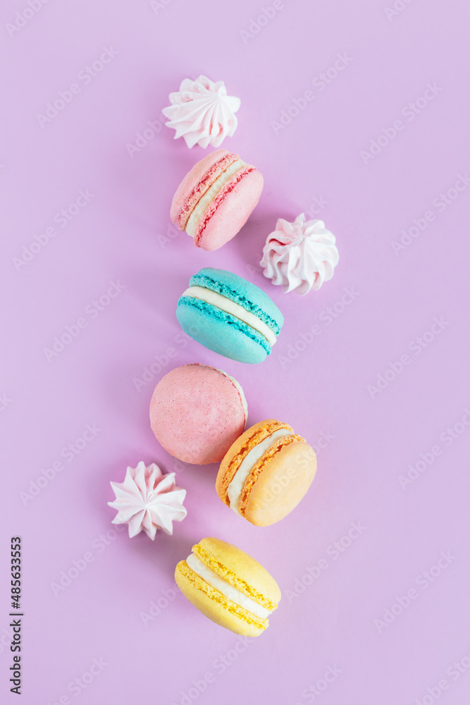 Tasty french macaroons on a violet pastel background. Tasty french macaroons on a violet pastel background.