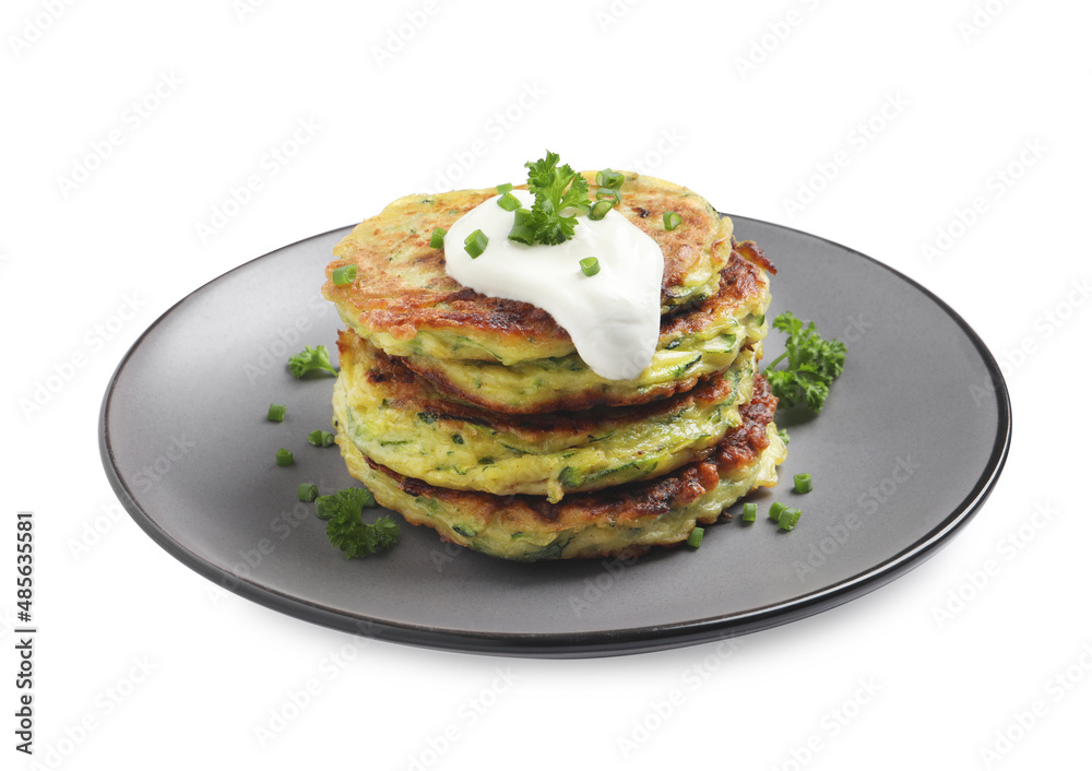 Delicious zucchini fritters with sour cream isolated on white Delicious zucchini fritters with sour cream isolated on white