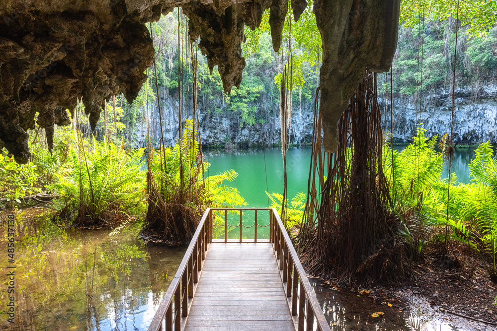 Three eyes cave in Santo Domingo, los Tres Ojos national park, Dominican Republic. Scenic view of limestone cave, beautiful lake and tropical plants, nature landscape, outdoor travel background - obrazy, fototapety, plakaty 