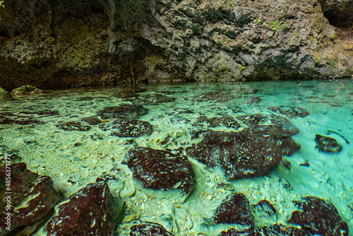 Three eyes cave in Santo Domingo, los Tres Ojos national park, Dominican Republic. Scenic view of limestone cave and crystal clear azure water of underground lake, nature landscape, travel background