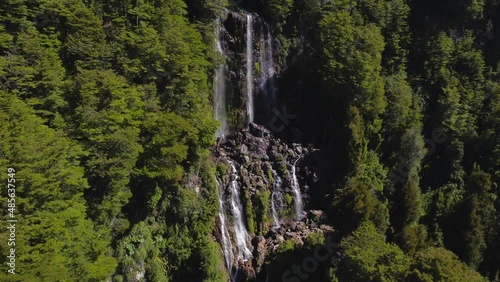 Waterfall on cliff surrounded by trees
