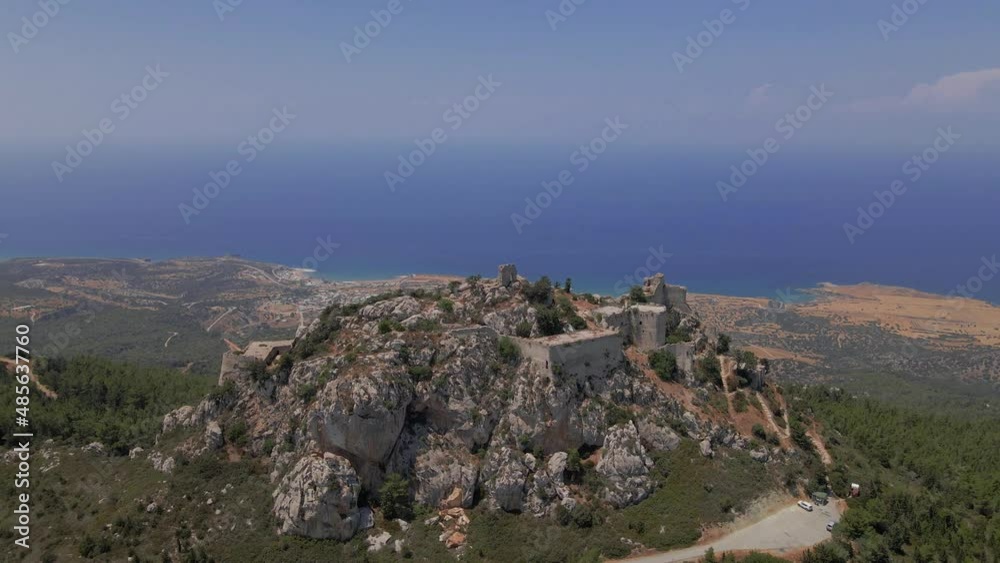 Aerial 4K landscape view of medieval Kantara Castle which is located at the Mountains in North Cyprus. Medieval Castle is surrounded with rocks & trees with an amazing view of Mediterranean Sea. Aerial 4K landscape view of medieval Kantara Castle which is located at the Mountains in North Cyprus. Medieval Castle is surrounded with rocks & trees with an amazing view of Mediterranean Sea.