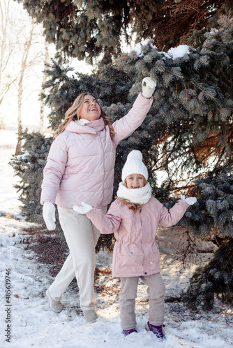 A little daughter and mother gently hug, kiss, showing love and expressing affection.Happy family, the pleasure of being a mom, congratulations on Mother's Day, the concept of a sweet moment together
