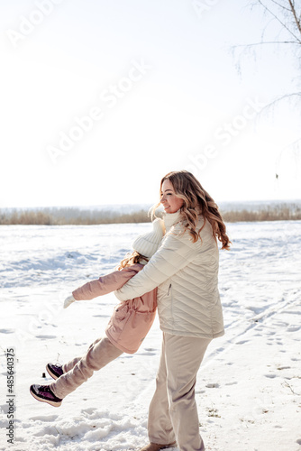 A little daughter and mother gently hug, kiss, showing love and expressing affection.Happy family, the pleasure of being a mom, congratulations on Mother's Day, the concept of a sweet moment together
