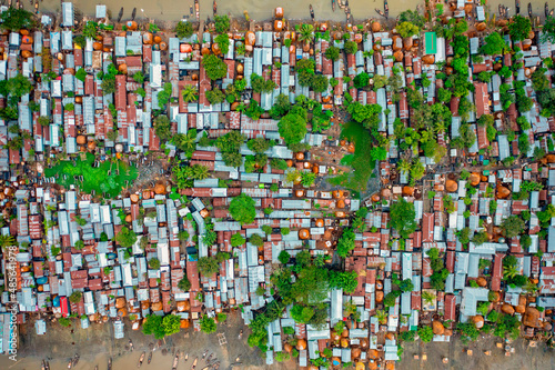 Aerial view of a huge residential area with barracks along the river in Dhaka, Bangladesh.