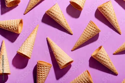 Bright pattern with ice cream cones on a purple background