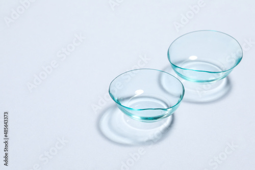 Pair of contact lenses on white background, space for text