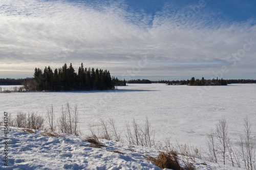 Frozen Astotin Lake on a Partially Cloudy Winter Day photo