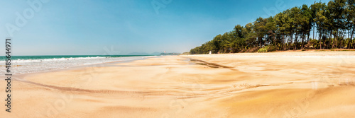 White sandy Galgibag Beach, with golden sand and blue sky, South Goa, India