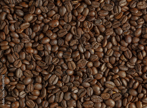 A blend of roasted Arabica and Robusta coffee beans background. ?offee of the highest quality